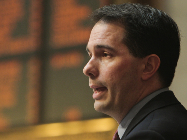 Wisconsin Gov. Scott Walker discusses his budget during a joint session of the Legislature at the state Capitol in Madison on Tuesday. Opponents to the governor's bill to cut collective bargaining rights for state workers have been protesting the governor's plans for two weeks at the Capitol.