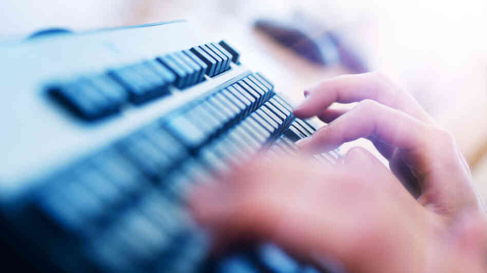 Fingers fly over a keyboard.