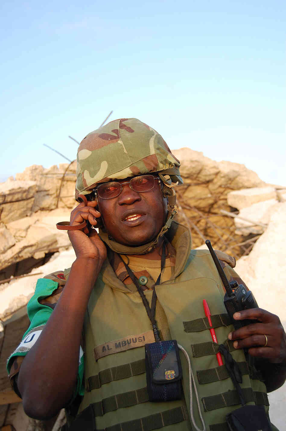 Maj. Anthony Lukwago Mbuusi of the Ugandan army listens to reports from the night's attacks on his firing positions in Mogadishu. Maj. Anthony Lukwago Mbuusi of the Ugandan army listens to reports from the night's attacks on his firing positions in Mogadishu.