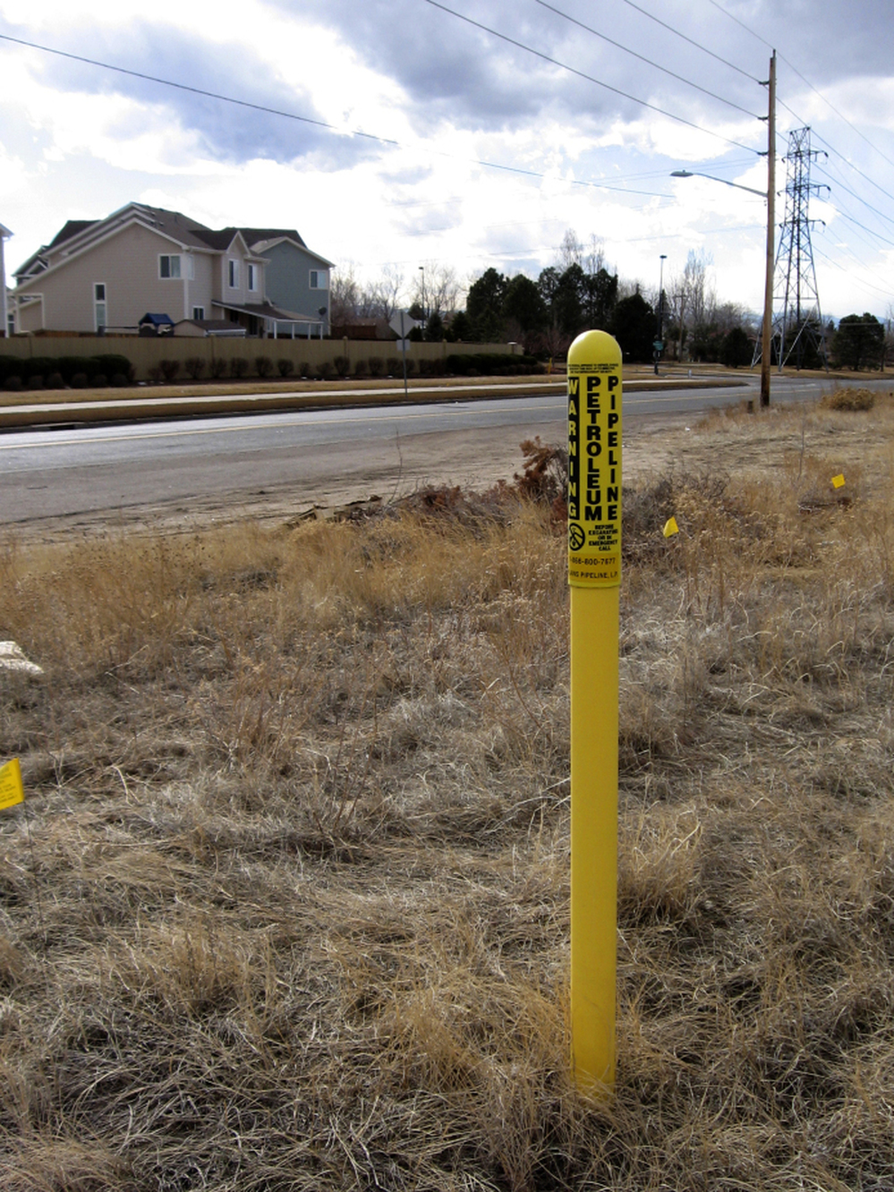 In Colorado, yellow warning poles designate the underground path of a gas pipeline.