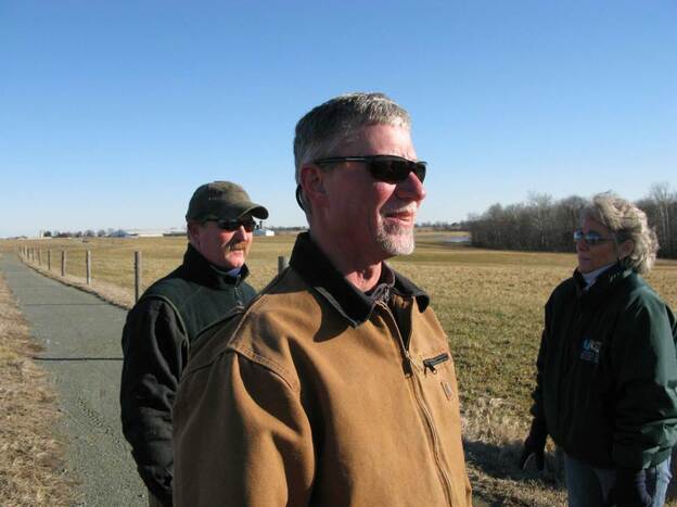 "We just make sure we're meeting the letter of the organic regulations to the T," says Tom Spohn (foreground), director of dairy operations for Horizon Organic. Behind him are farm manager Dudley McHenry and Sissy Everett.
