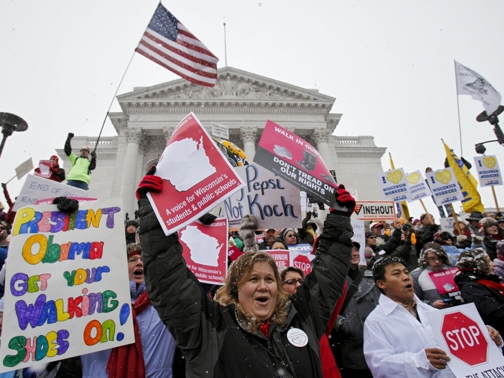 Teacher Kristen Henningfeld, center, of Elk Mound, Wis., protests on the  steps of the state Capitol in Madison, Wis., on Feb. 26.