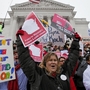 Teacher Kristen Henningfeld, center, of Elk Mound, Wis., protests on the  steps of the state Capitol in Madison, Wis., on Feb. 26.