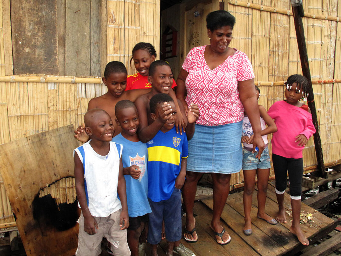 Fifty-year-old Segunda Ayobi, with her extended  family. Ayobi, who lives in a slum in Guayaquil, Ecuador, enrolled her son Mario in a  shelter when he began to miss school, to keep him away from drugs and  trouble.