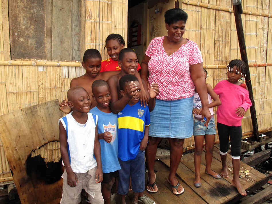 Fifty-year-old Segunda Ayobi, with her extended  family. Ayobi, who lives in a slum in Guayaquil, Ecuador, enrolled her son Mario in a  shelter when he began to miss school, to keep him away from drugs and  trouble.
