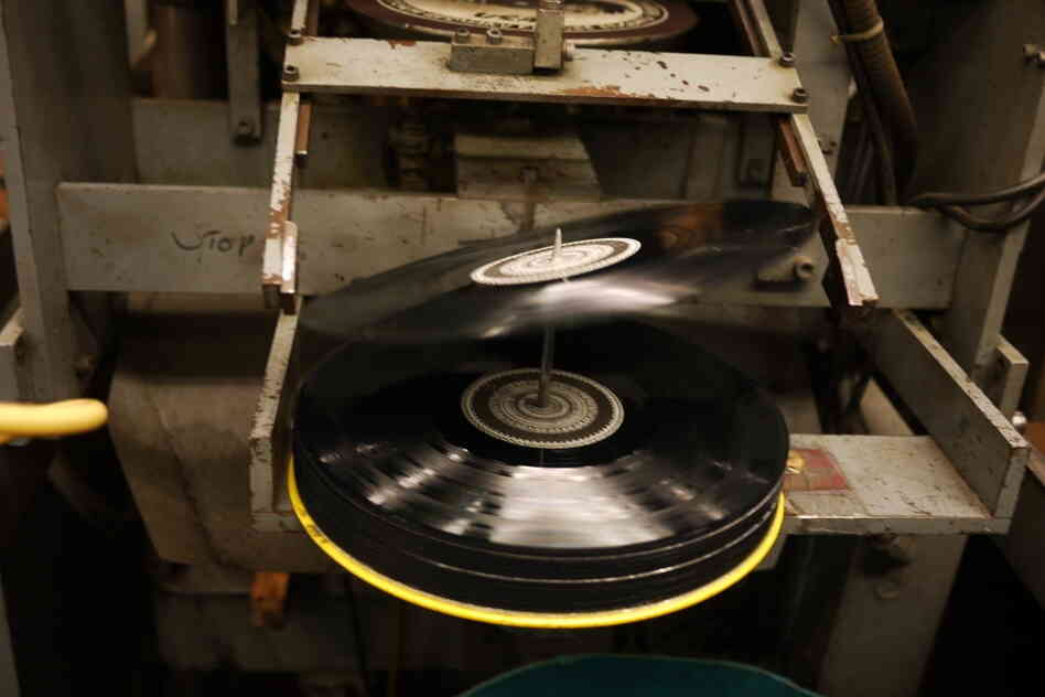 A 12-inch record tips onto the spindle at EKS Manufacturing. A 12-inch record tips onto the spindle at EKS Manufacturing.