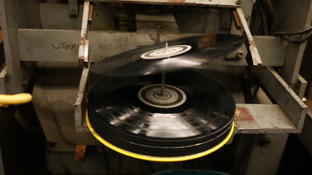A 12-inch record tips onto the spindle at EKS Manufacturing. (Jacob Ganz)