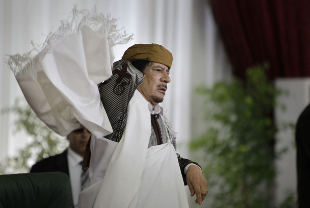 Libyan Leader Moammar Gadhafi adjusts his gown after speaking to supporters and the media in Tripoli on Wednesday.