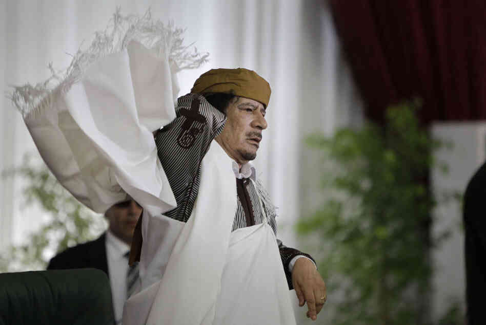 Libyan Leader Moammar Gadhafi adjusts his gown after speaking to supporters and the media in Tripoli on Wednesday.