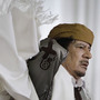 Libyan Leader Moammar Gadhafi adjusts his gown after speaking to supporters and the media in Tripoli on Wednesday.