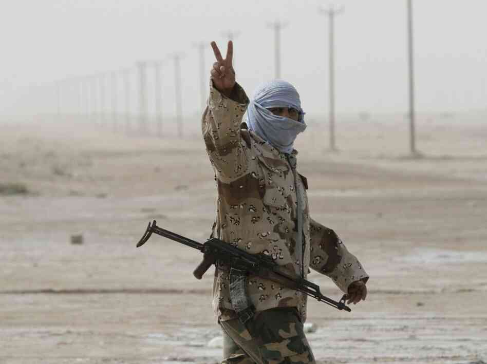 A Libyan rebel soldier flashes the "V for victory" sign as he prepares for battle in the eastern city of Ajdabiya on Wednesday. A Libyan rebel soldier flashes the "V for victory" sign as he prepares for battle in the eastern city of Ajdabiya on Wednesday.