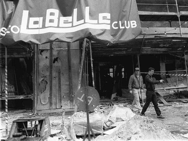 Two plainclothes U.S. military police officers walk around the scene of a bombing at the La Belle discotheque in West Berlin in this April 1986 file photo.