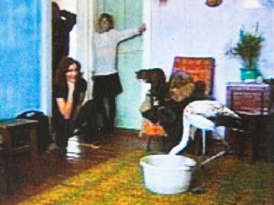 The flamingo eating from a bucket in the living room of the Muravyev's apartment.