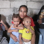 Maribel Olmedo sits in her house, surrounded by some  of her children, including Hamilton (from left), 16, Jonathan, 12, Pierina, 2, and Jose, 1. The  family struggles to make ends meet, but Olmedo says she is grateful her children are  alive.