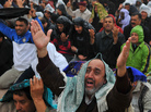 An anti-Gadhafi protester, front, reacts during Friday prayers at the court square in Benghazi, eastern Libya, Friday. Fighters loyal to Gadhafi set up checkpoints in Tripoli ahead of planned anti-government protests Friday. An anti-Gadhafi protester, front, reacts during Friday prayers at the court square in Benghazi, eastern Libya, Friday. Fighters loyal to Gadhafi set up checkpoints in Tripoli ahead of planned anti-government protests Friday.