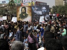 Demonstrators gather in Baghdad's Tahrir Square Friday, despite a curfew and security checkpoints around the square. Demonstrators gather in Baghdad's Tahrir Square Friday, despite a curfew and security checkpoints around the square.