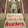 A sign supporting teachers is taped to the railing above a stairway in the Wisconsin state Capitol last month, as activists protested what they call an anti-union measure. A sign supporting teachers is taped to the railing above a stairway in the Wisconsin state Capitol last month, as activists protested what they call an anti-union measure.