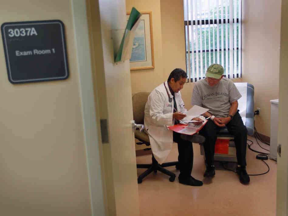 A man gets a checkup from Dr. Olveen Carrasquillo at the University of Miami's Miller School of Medicine in January.