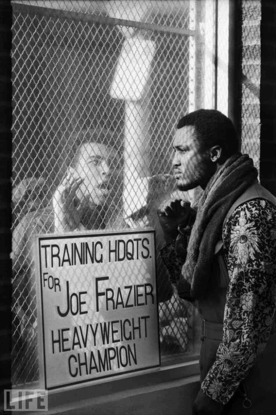 Muhammad Ali taunts Joe Frazier in Pennsylvania at Frazier's training headquarters. Both Shearer's photos and the 1971 Life article portray the outspoken aggression between the fighters. Muhammad Ali taunts Joe Frazier in Pennsylvania at Frazier's training headquarters. Both Shearer's photos and the 1971 Life article portray the outspoken aggression between the fighters.
