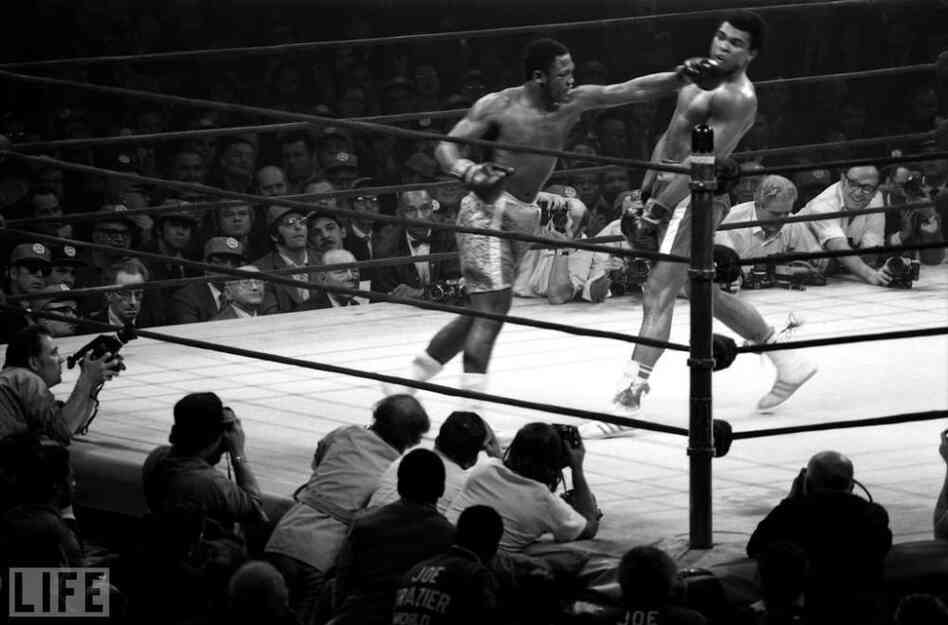 Muhammad Ali dodges a hook thrown by Joe Frazier.  Knocked down in the 15th and final round, Ali lost by a unanimous decision, his  first professional defeat.