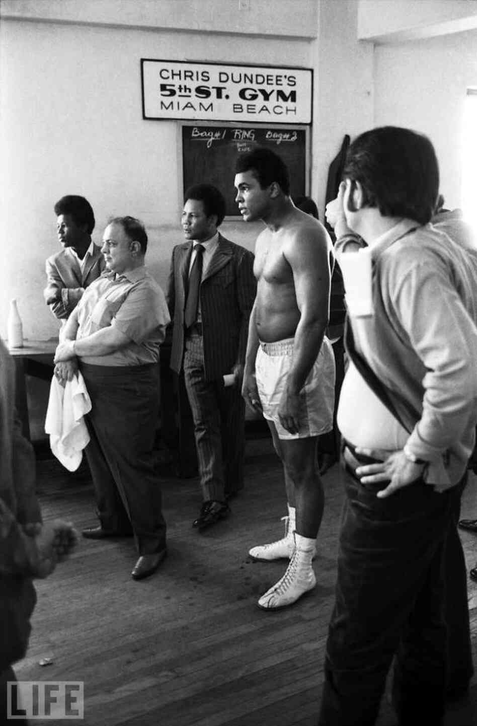 Ali, along with Puerto Rican light heavyweight Jose Torres (in suit) and others, gather at legendary boxing promoter Chris Dundee's gym in Miami Beach, Fla., in February 1971. Ali, along with Puerto Rican light heavyweight Jose Torres (in suit) and others, gather at legendary boxing promoter Chris Dundee's gym in Miami Beach, Fla., in February 1971.