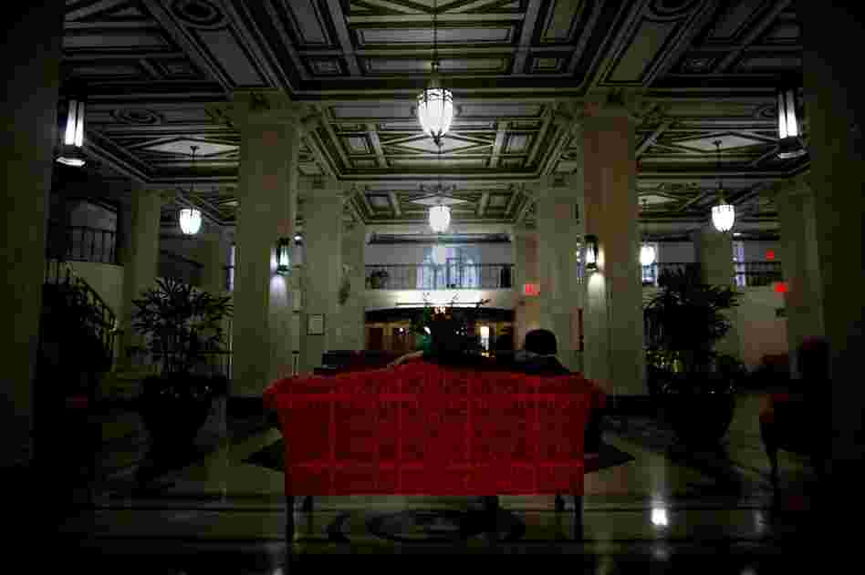 The grand two-story lobby of the Times Square Building boasts marble floors and gold-trimmed ceilings. Common Ground redeveloped the once-dilapidated building into 652 units for low-income and formerly homeless tenants in 1991.
