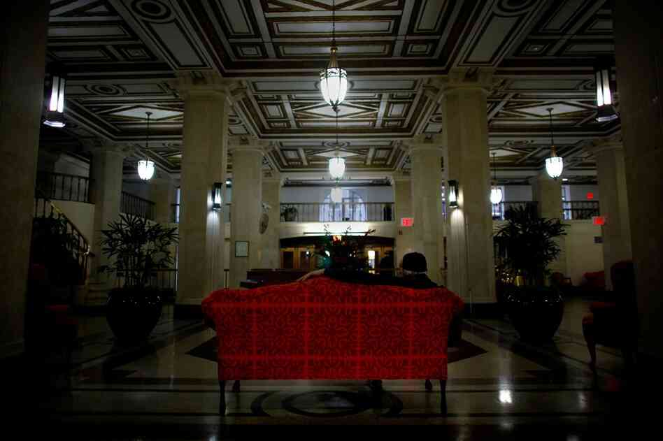 The grand two-story lobby of the Times Square Building boasts marble floors and gold-trimmed ceilings. Common Ground redeveloped the once-dilapidated building into 652 units for low-income and formerly homeless tenants in 1991.