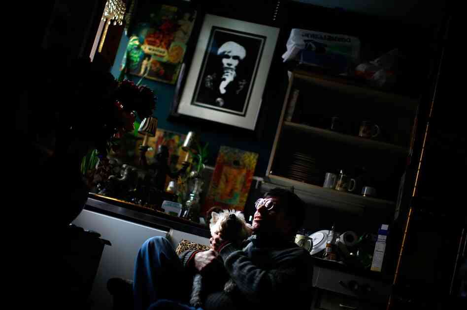 Martin Michael Fitzgerald III sits in his studio apartment with his dog Miss Lilibet.