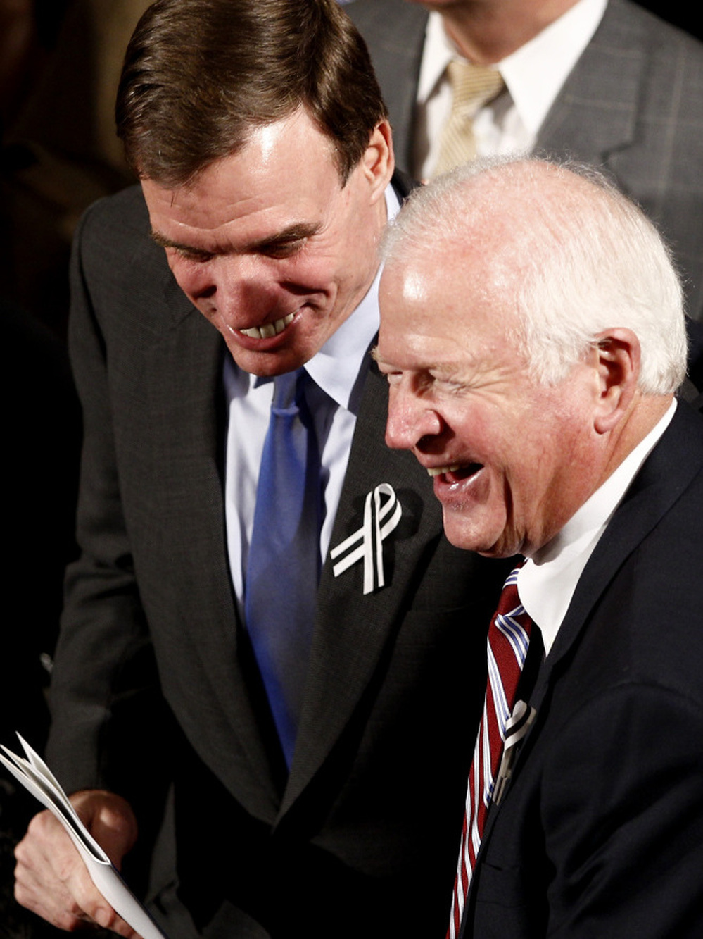 Sens. Mark Warner (D-VA, left) and Saxby Chambliss (R-GA), shown before the start of President Obama's State of the Union address in January. The two senators are part of the so-called Gang of Six — a bipartisan group that hopes to break a deadlock and reduce the federal deficit.