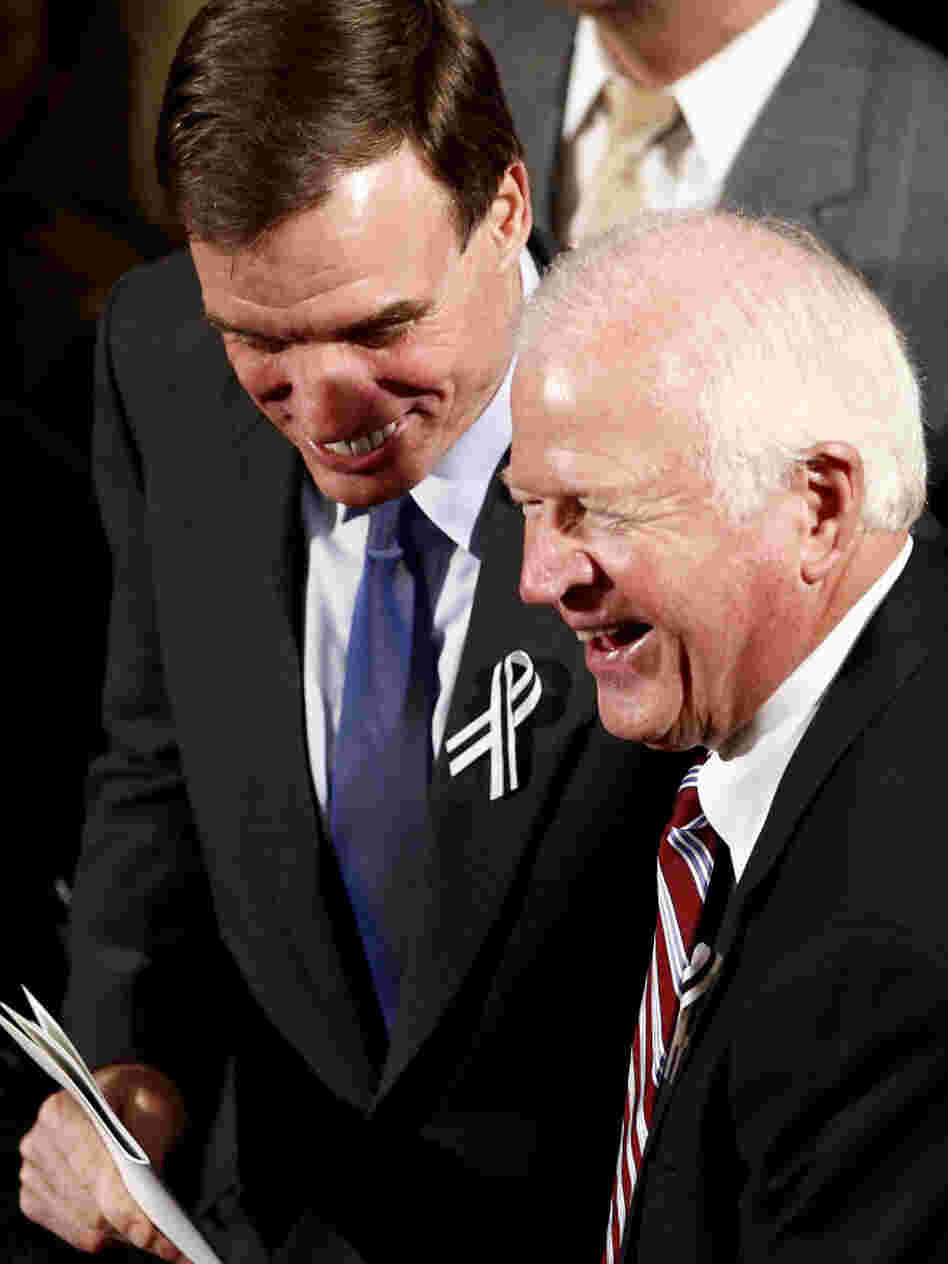 Sens. Mark Warner (D-VA, left) and Saxby Chambliss (R-GA), shown before the start of President Obama's State of the Union address in January. The two senators are part of the so-called Gang of Six — a bipartisan group that hopes to break a deadlock and reduce the federal deficit.
