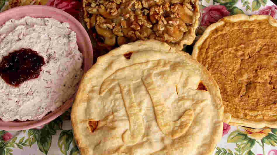 Four pies on a floral tablecloth