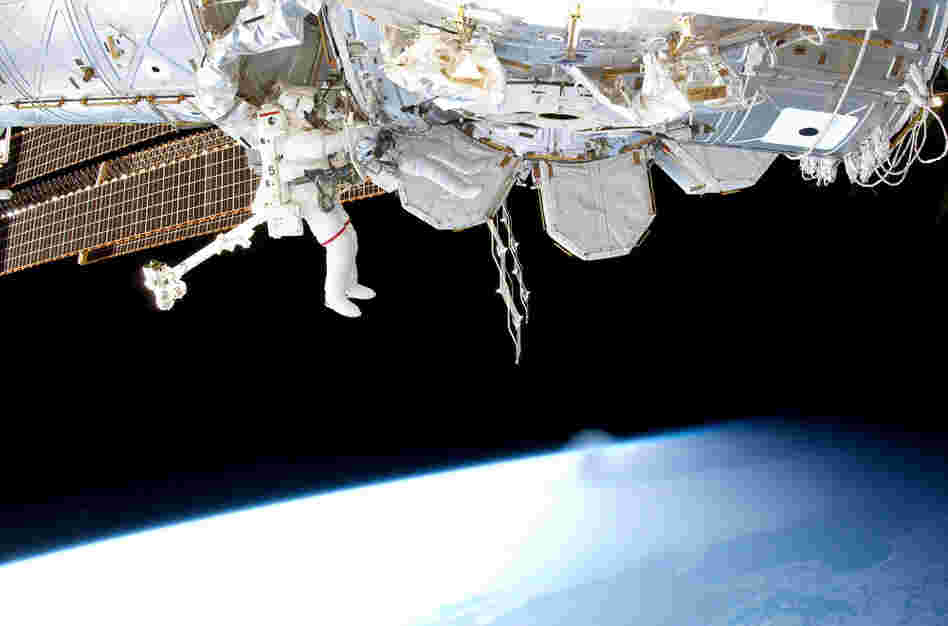 Steve Bowen (left) and Alvin Drew  work on space station maintenance. The two installed a power cable and moved an ammonia pump during a spacewalk on Feb. 28.