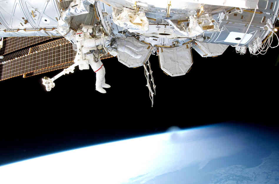 Steve Bowen (left) and Alvin Drew  work on space station maintenance. The two installed a power cable and moved an ammonia pump during a spacewalk on Feb. 28.