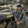 A soldier from the Libyan military's elite Khamis Brigade, led by Moammar Gadhafi's son, takes a position in Harshan, Libya, on Feb. 28. The Khamis Brigade is one of the elite units Gadhafi has bolstered while keeping the regular army weak, analysts say. A soldier from the Libyan military's elite Khamis Brigade, led by Moammar Gadhafi's son, takes a position in Harshan, Libya, on Feb. 28. The Khamis Brigade is one of the elite units Gadhafi has bolstered while keeping the regular army weak, analysts say.