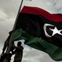 Rebel fighters in Libya raise a pre-Gadhafi flag Tuesday on the outskirts of the eastern town of Ras Lanuf. Rebel fighters in Libya raise a pre-Gadhafi flag Tuesday on the outskirts of the eastern town of Ras Lanuf.