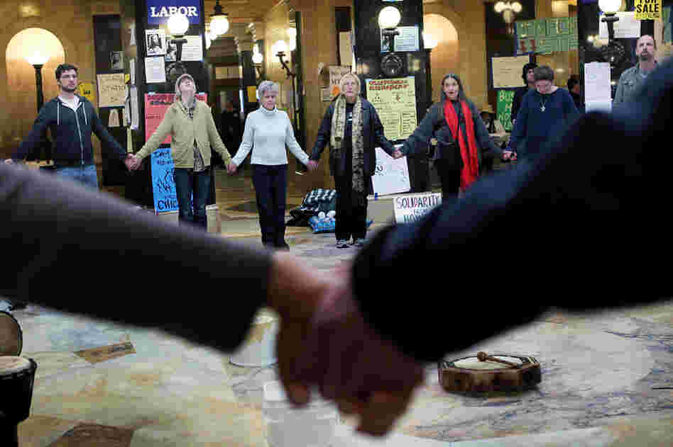 Protesters hold hands and chant in the Capitol rotunda on March 3 during around-the-clock demonstrations. 