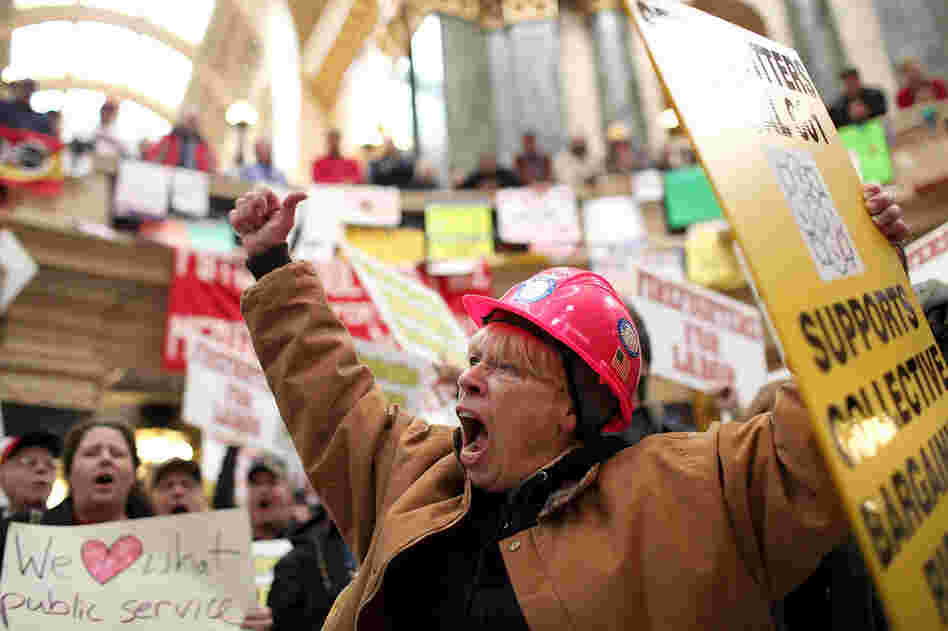 Union members return to protest inside the Capitol on March 4. They were forced to vacate the building after occupying it for more than two weeks.  