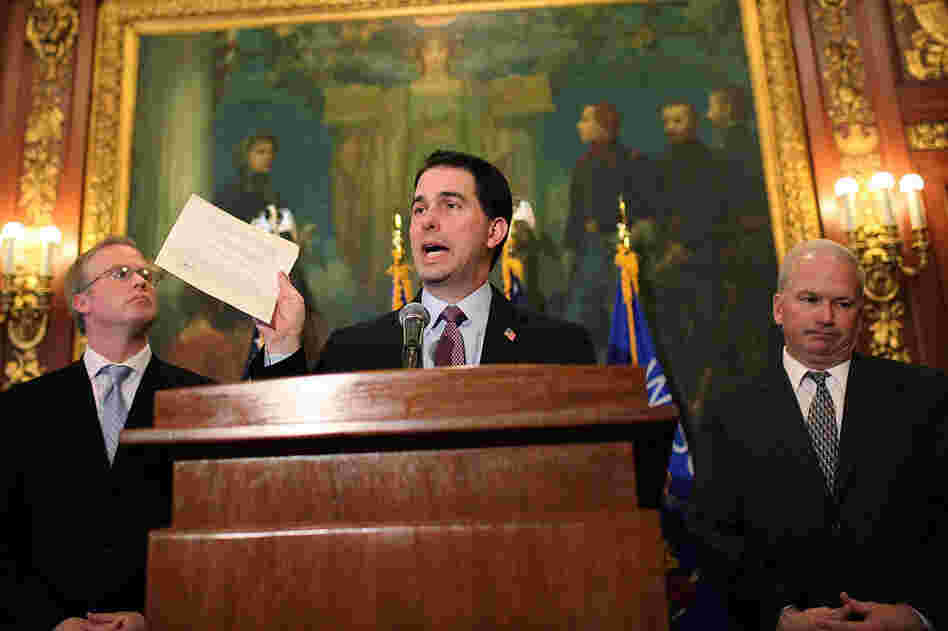 Wisconsin Gov. Scott Walker holds a letter from Democratic state Sen. Mark Miller, one of the 14 senators who fled the state more than two weeks ago, during a press conference Monday. 