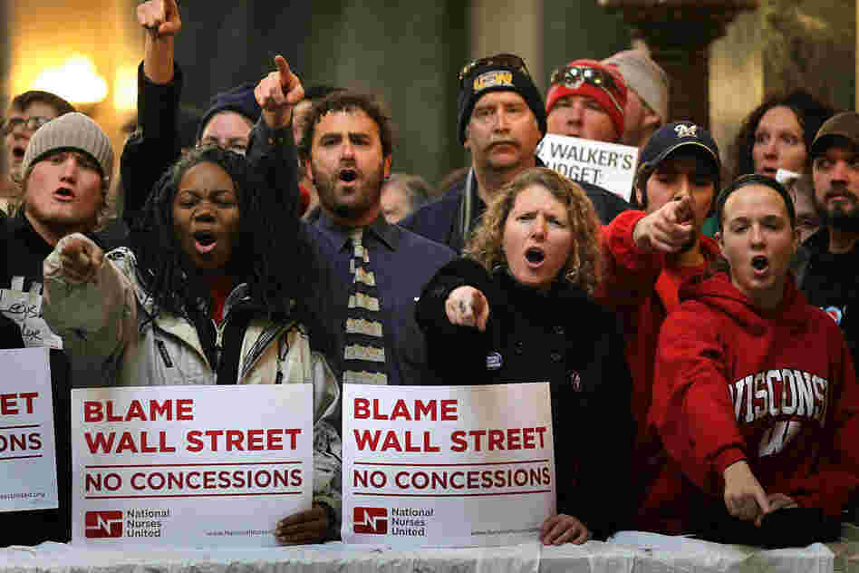 Protesters yell outside the chamber as members of the Wisconsin state Assembly debate the state's budget bill on Thursday. Thousands of demonstrators took over the Capitol after the Wisconsin state Senate voted to curb collective bargaining rights for public union workers in a surprise vote with no Democrats present. The measure passed the Assembly 53-42. 