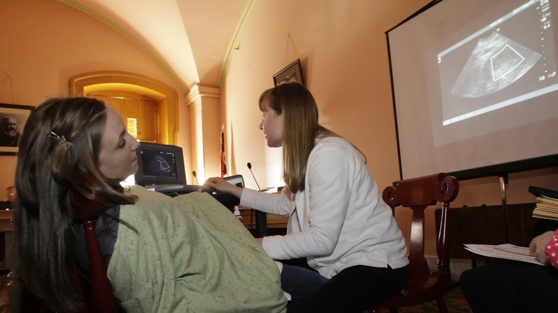 Registered nurse Julie Aber (right), of the Ashland Care Center in Ohio,  administers an ultrasound to Erin Glockner, as testimony on House Bill 125 continues in Columbus on March 2. House Bill 125, also known as the heartbeat  bill, prohibits abortions after the first detectable heartbeat.