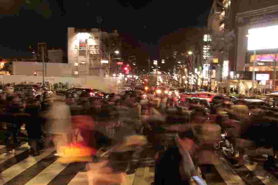 Commuters walk through Tokyo after train services were suspended due to the earthquake. 