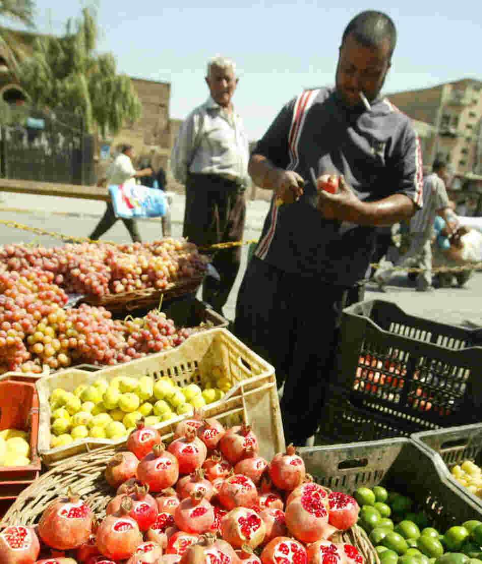 An Iraqi cuts a pomegranate on his fruit stall at the Al-Shorja market, central Baghdad, in 2007. In her book Day of Honey, author Annia Ciazadlo says she visited the local Bagdhad markets when first arriving as a reporter in order "to to comprehend the place I've landed in, to touch and feel and take in the raw materials of my new surroundings." An Iraqi cuts a pomegranate on his fruit stall at the Al-Shorja market, central Baghdad, in 2007. In her book Day of Honey, author Annia Ciazadlo says she visited the local Bagdhad markets when first arriving as a reporter in order "to to comprehend the place I've landed in, to touch and feel and take in the raw materials of my new surroundings."