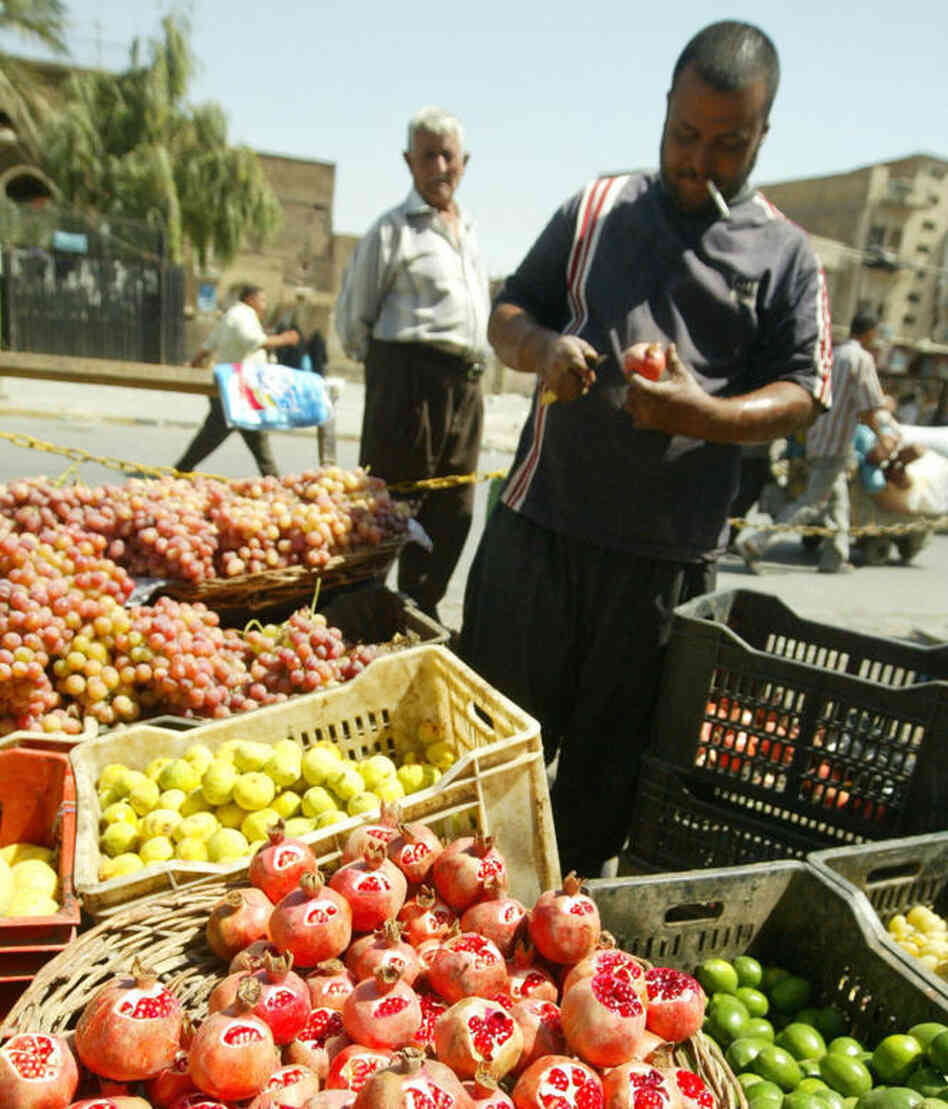 An Iraqi cuts a pomegranate on his fruit stall at the Al-Shorja market, central Baghdad, in 2007. In her book Day of Honey, author Annia Ciazadlo says she visited the local Bagdhad markets when first arriving as a reporter in order "to to comprehend the place I've landed in, to touch and feel and take in the raw materials of my new surroundings." An Iraqi cuts a pomegranate on his fruit stall at the Al-Shorja market, central Baghdad, in 2007. In her book Day of Honey, author Annia Ciazadlo says she visited the local Bagdhad markets when first arriving as a reporter in order "to to comprehend the place I've landed in, to touch and feel and take in the raw materials of my new surroundings."