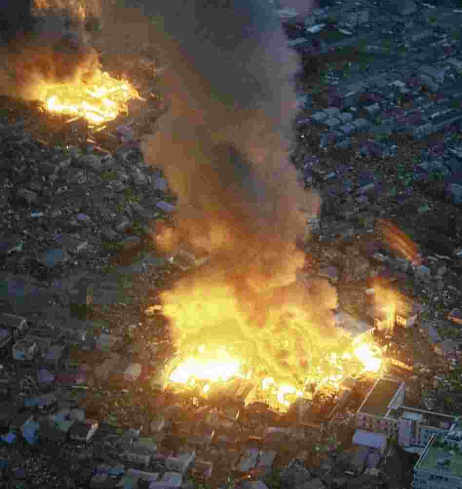Buildings burn in Yamada town, Iwate prefecture, after Japan's biggest recorded earthquake hit. 