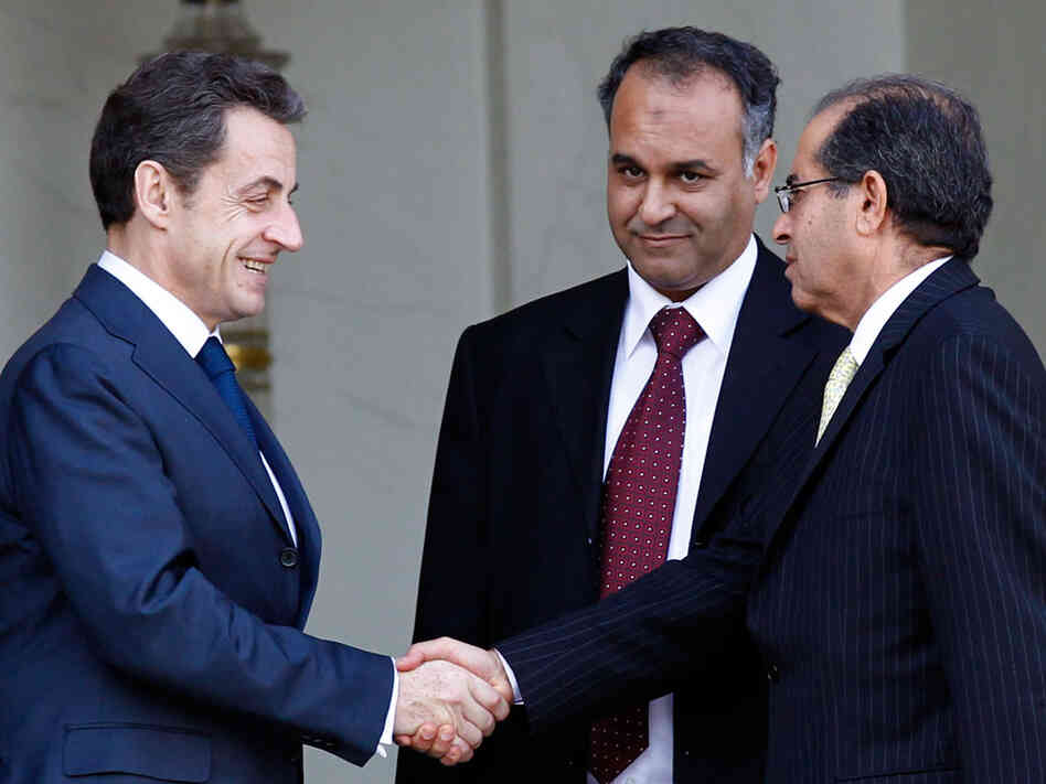 French President Nicolas Sarkozy (left) shakes hands with Mahmood Jibril (right) and Ali Al Issawi, representatives of the newly formed Interim Transitional National Council in Libya, after a meeting at the Elysee Palace in Paris on March 10. French President Nicolas Sarkozy (left) shakes hands with Mahmood Jibril (right) and Ali Al Issawi, representatives of the newly formed Interim Transitional National Council in Libya, after a meeting at the Elysee Palace in Paris on March 10.