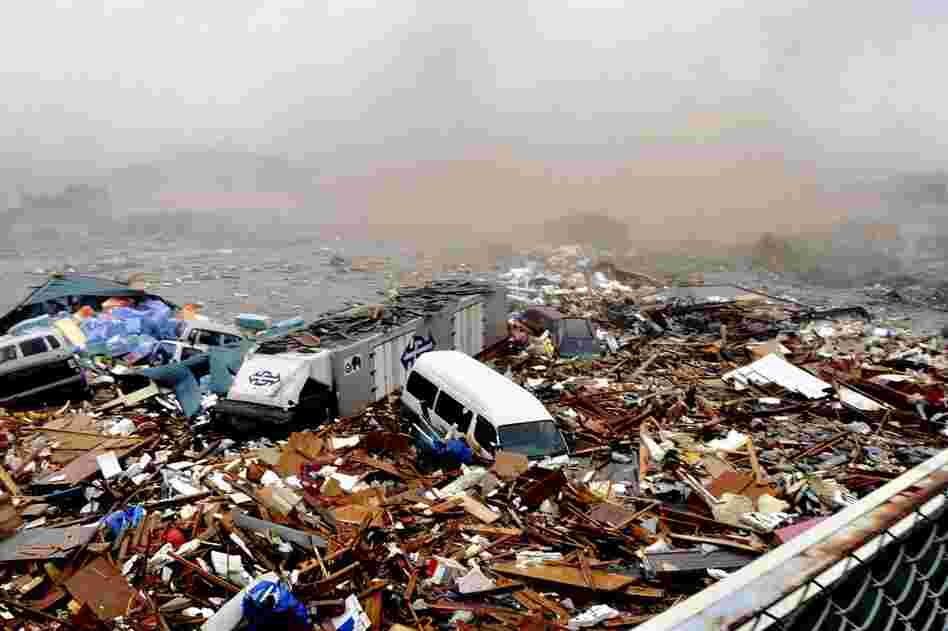 Cars and other debris swept away by a tsunami pile up in Kesennuma. 