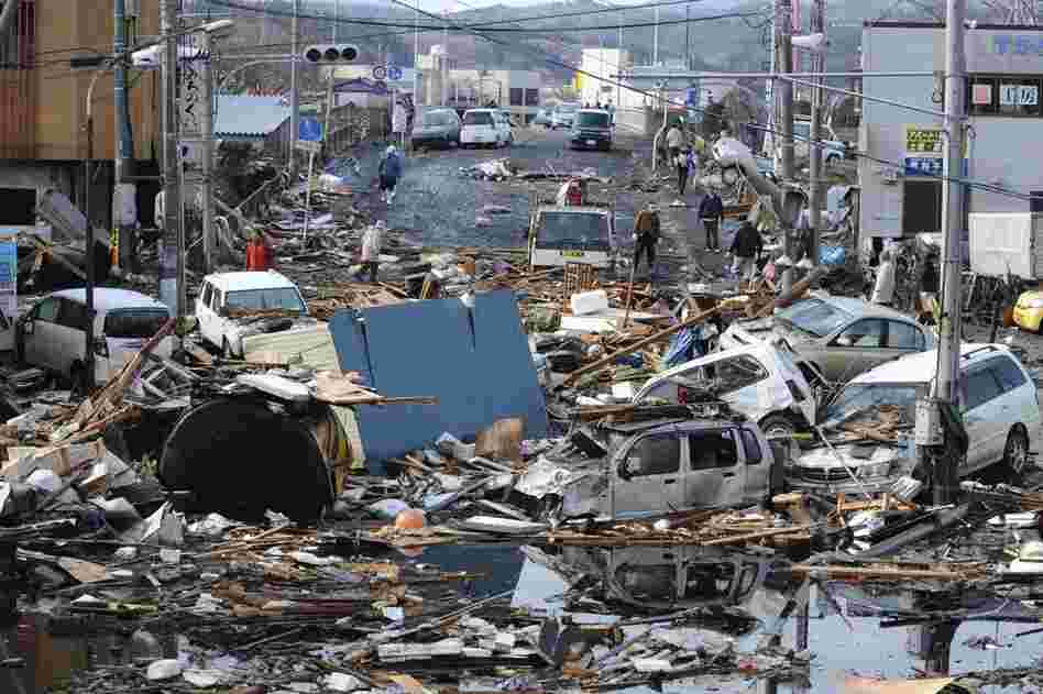 Vehicles and rubble cover a road in the city of Kesennuma in northern Japan. 
