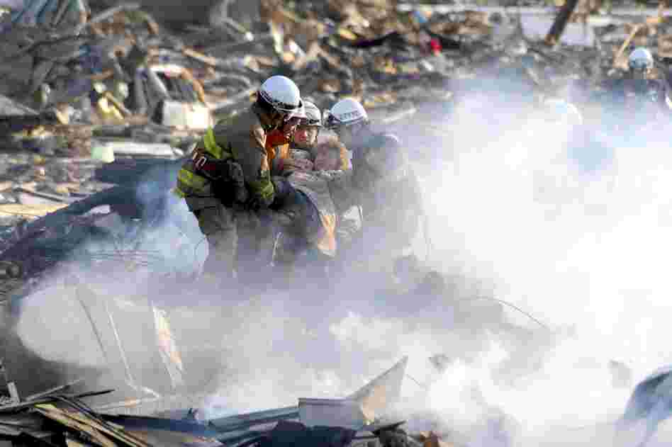 A resident is rescued from debris in Natori, northeast Japan. 