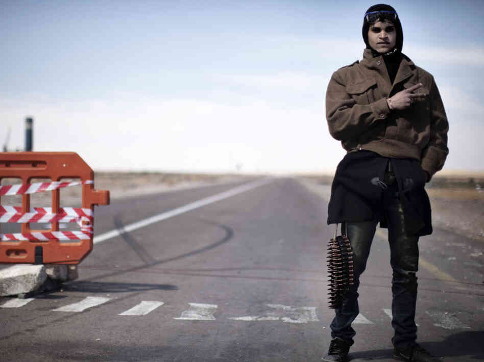 A lone rebel mans the last checkpoint before the flashpoint Libyan town of Ras Lanuf on Saturday. A lone rebel mans the last checkpoint before the flashpoint Libyan town of Ras Lanuf on Saturday.