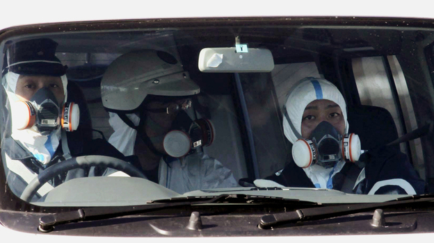 Police officers wore gas masks as they patrolled near the nuclear power plant in Fukushima prefecture today (March 12, 2011).